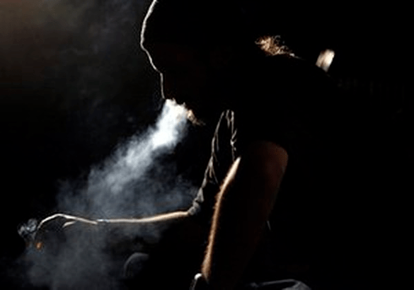 the man smokes a cigarette